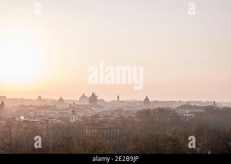 Skyline view of Rome, Italy, from Trastevere at sunrise. Famous landmarks and domes outlined in silhouette. Stock Photo