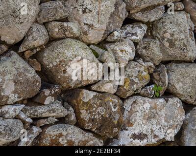Background. Texture. The wall made of multi-sized stones Stock Photo