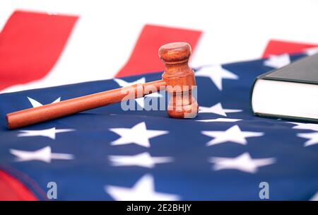Wooden judge gavel on USA flag, conceptual image about court Stock Photo