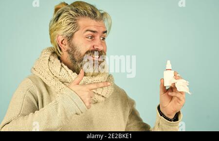 no addiction to medicals. coronavirus from china. happy hipster presenting best remedy. Nasal drops plastic bottle. pandemic concept. man treat runny nose with nasal spray. free your stuffy nose. Stock Photo