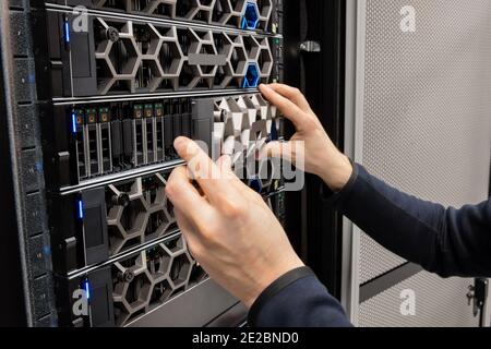 Hands Of Male Computer Engineer Monitoring Hyperconverged Servers in Datacenter Stock Photo