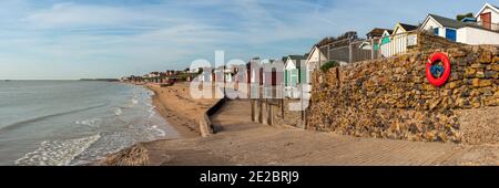 WALTON-ON-THE NAZE, ESSEX, UK - APRIL 05, 2009:  Panorama view along the beach and seafront with its colourful Beach Hut Stock Photo