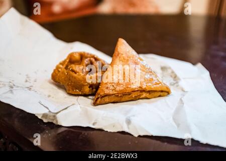 Chebakia and briwat are Moroccan bakery goods, with Chebakie being a sweet honey-dipped cookie and briwat being a puff pastry Stock Photo