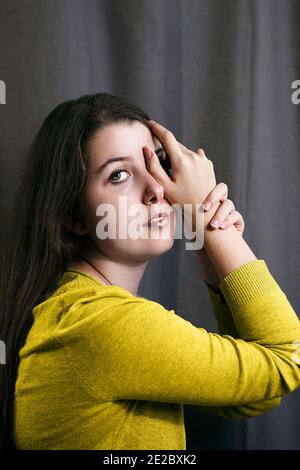 young teenager with yellow sweater in romantic attitude Stock Photo