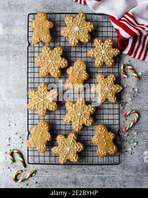 Overhead of gingerbread cookies on wire rack on grey stone counter. Stock Photo
