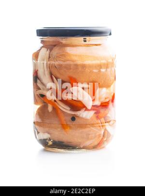 Pickled sausages with onion and red pepper. Marinated food in jar isolated on white background. Stock Photo
