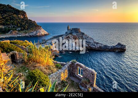 San Pietro church in Porto Venere against a dramatic sunset at the sea. Photo taken on 28th of September 2016 from Doria castle in the town of Porto V Stock Photo