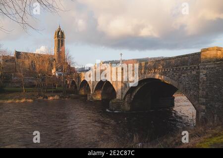 The Old Parish Church of Peebles as seen from across the stone-built Peebles Bridge over the River Tweed.