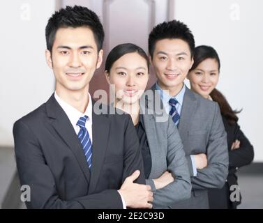 Four young office workers with hands crossed indoors,portrait high quality photo Stock Photo