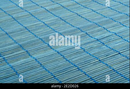 Full frame of blue bamboo food mat diagonal. Traditional kitchen utensils. Stock Photo