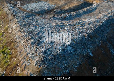 Waste disposal site or landfill with plastic and other inorganic waste harmful to nature, aerial view. Stock Photo