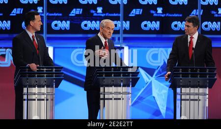 Republican presidential candidate Rep. Ron Paul (R-TX) speaks as Texas Governor Rick Perry, and former Sen. Rick Santorum (R-PA) look on during a presidential debate at DAR Constitution Hall organized by CNN in Washington, DC, USA, November 22, 2011. Photo by Olivier Douliery/ABACAPRESS.COM Stock Photo