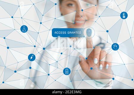 Female doctor logging into electronic patient account. Innovative technologies in medicine Stock Photo