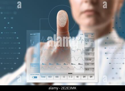 Emergency physician using patient monitoring system, closeup. Innovative technologies in medicine Stock Photo