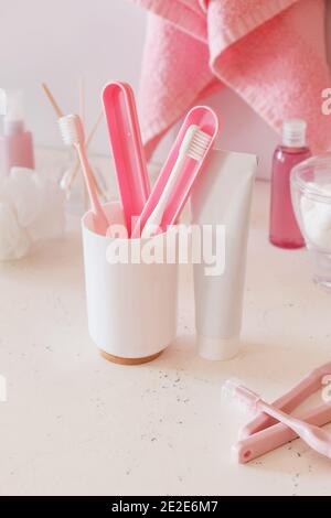 Set of oral hygiene and bath accessories on table in bathroom Stock Photo