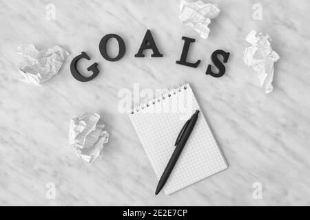 Notebook, pen and word GOALS on light background Stock Photo