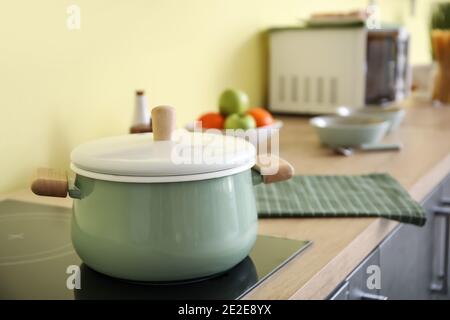 Cooking pot on electric stove in kitchen Stock Photo