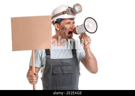 Protesting miner man with megaphone and placard on white background Stock Photo