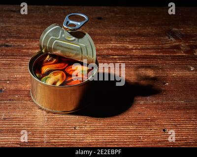 High angle shot of tinned mussels with a brown oily sauce on a can Stock Photo
