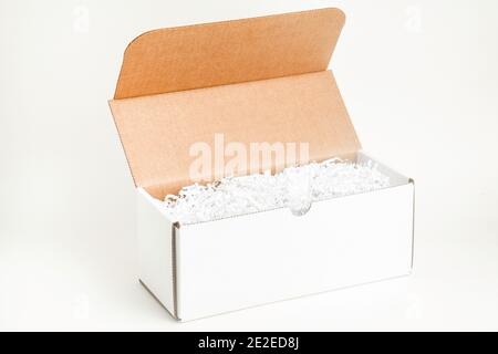 An open white rectangular cardboard packaging box set on plain white background. Stock Photo