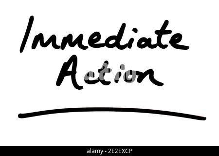 Immediate Action handwritten on a white background. Stock Photo