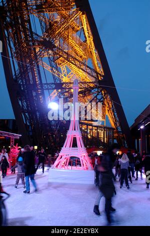 Skaters gliding along the ice on the first floor of the Eiffel Tower, 57 meters above ground level, on the first floor of the Eiffel Tower in Paris, France, December 20, 2011. The rink will only be in operation until February 1st. It is the second consecutive year that the ice skating rink opens in the Eiffel Tower. At 200 square meters (2,150 sq feet), it is only about a third of the size of New York's famed Rockefeller Center ice rink. Last year, more than 1,000 skaters visited the Tower's frozen surface, dubbed 'a popular success,' by organizers of the initiative. Skates can be hired for 5 Stock Photo