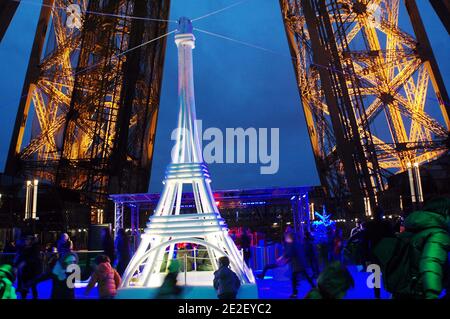 Skaters gliding along the ice on the first floor of the Eiffel Tower, 57 meters above ground level, on the first floor of the Eiffel Tower in Paris, France, December 20, 2011. The rink will only be in operation until February 1st. It is the second consecutive year that the ice skating rink opens in the Eiffel Tower. At 200 square meters (2,150 sq feet), it is only about a third of the size of New York's famed Rockefeller Center ice rink. Last year, more than 1,000 skaters visited the Tower's frozen surface, dubbed 'a popular success,' by organizers of the initiative. Skates can be hired for 5 Stock Photo