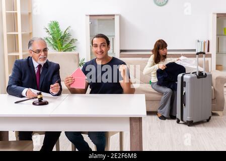 Old judge and young couple in divorcing concept Stock Photo