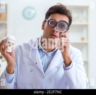 The crazy doctor studying human skeleton Stock Photo