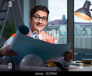 The construction architect working on drawings late at night Stock Photo