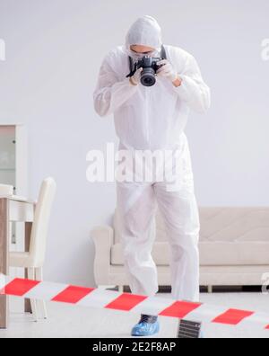 The forensic expert at crime scene doing investigation Stock Photo