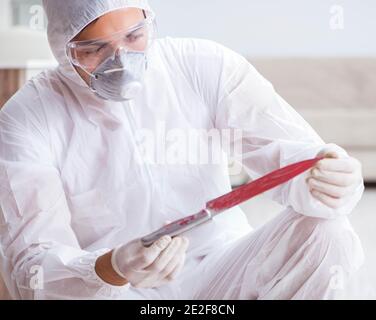 The forensic expert at crime scene doing investigation Stock Photo
