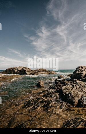 A view of the waves hitting the rocky cliffs Stock Photo - Alamy