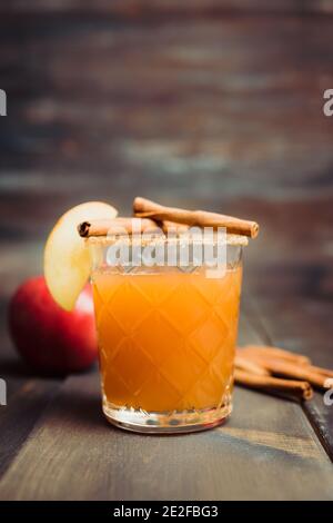 Old-fashioned cocktail based on freshly squeezed apple juice with cinnamon spices. Drinks and beverages. Selective focus. Shallow depth of field. Stock Photo