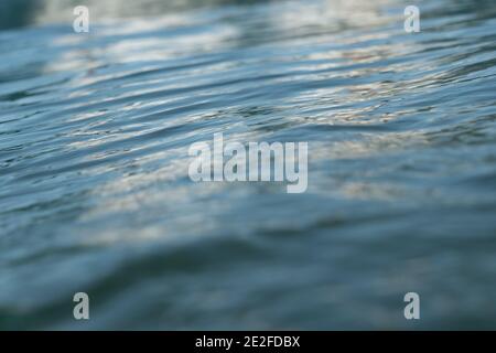 Close up shallow focus of sea, ocean, water, ripples with reflection. Stock Photo