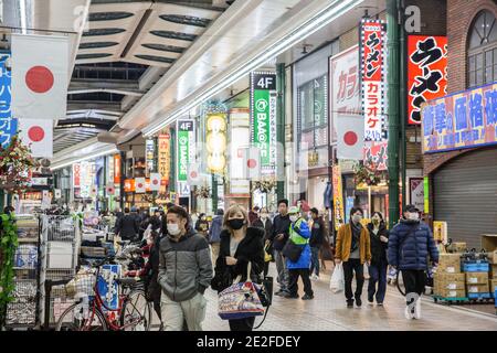 Kawasaki, Japan. 13th Jan, 2021. Pedestrians with face masks walk on Ginryugai street in Kawasaki. Credit: SOPA Images Limited/Alamy Live News Stock Photo