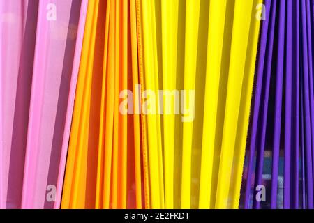 Beautiful multi-colored curtains decorated as a backdrop for the Buddhist ceremonies in Southeast Asia. Fabric colour and texture swatches. Background Stock Photo