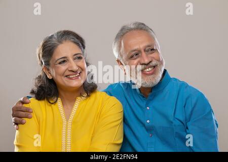 OLD COUPLE LOOKING AWAY HAPPILY Stock Photo