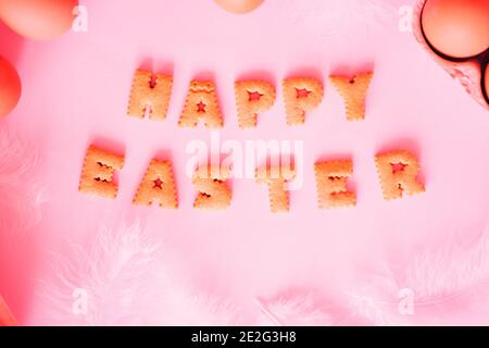 Happy Easter lettering on colored background with eggs Stock Photo