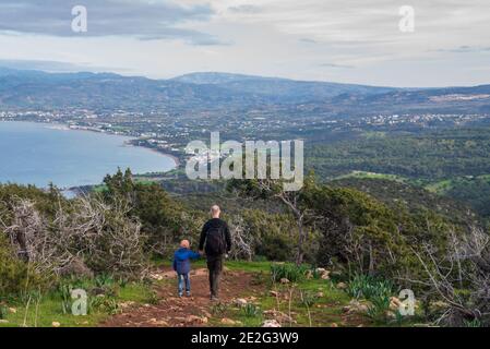 Father and son walking in Cyprus mountains with stunning view to island Stock Photo