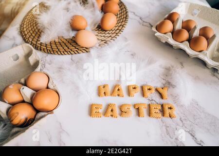 Easter, a table with eggs and the inscription happy Easter Stock Photo