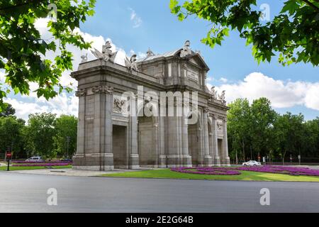 Unusual view of the Puerta de Alcala with the Retiro park behind it. Famous places of the city of Madrid. Stock Photo