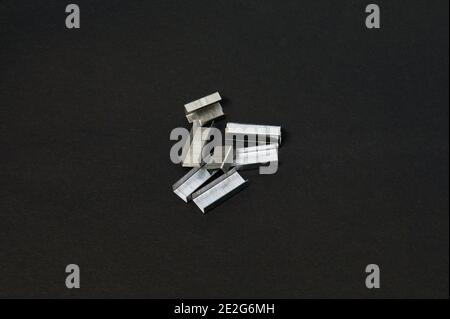Stapler pins on a black background Stock Photo