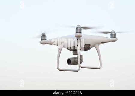 Shot of a drone quadcopter with a high-resolution digital camera on white background. Stock Photo