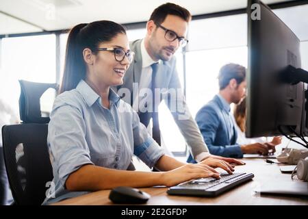 Programmers cooperating at IT company developing apps Stock Photo