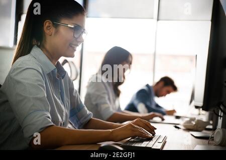 Programmers cooperating at IT company developing apps Stock Photo