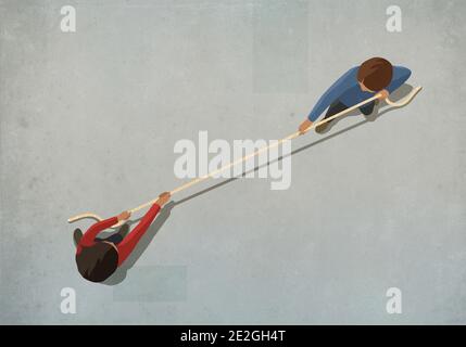 Couple engaging in tug of war with rope Stock Photo