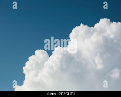 Fluffy white clouds in sunny blue sky Stock Photo
