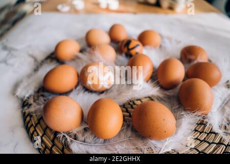 Easter eggs on the table closeup. Creative process of making decorations for holiday. Stock Photo