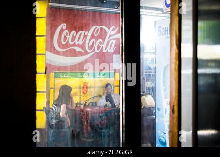 Two ladies waiting for a bus at a bus station in Dimitrovgrad, Bulgaria Stock Photo